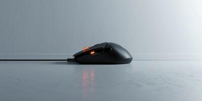 Image of a sleek, black mouse placed centrally on a minimalist grey surface. The design emphasizes simplicity and functionality, appealing to modern aesthetics. photo