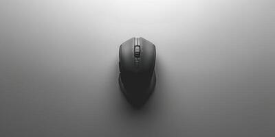 Image of a sleek, black mouse placed centrally on a minimalist grey surface. The design emphasizes simplicity and functionality, appealing to modern aesthetics. photo