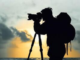 man hold camera on the cliff of the mountain on sunset background, photo