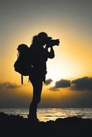 people and sun concept, woman hold camera on the cliff of the mountain on sunset background, photo