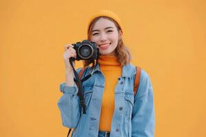 woman holding camera on solid bright background. photo