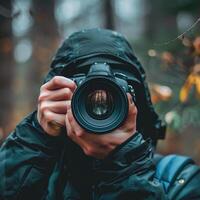 man hand holding camera looking through lens. photo