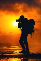man hold camera on the cliff of the mountain on sunset background, photo