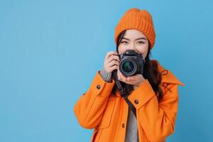 woman holding camera on solid bright background. photo
