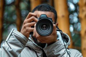 man hand holding camera looking through lens. photo