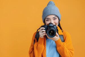 woman holding camera on solid bright background. photo