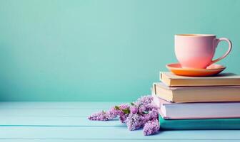 Stack of books on a light blue table with a pastel lavender background photo