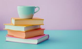 Stack of books on a light blue table with a pastel lavender background photo