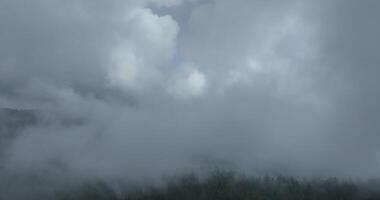 Aerial hyperlapse timelapse aerial view of clouds and mountains with green forest video
