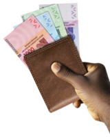 Black Hand Holding brown wallet With West African CFA franc notes. png