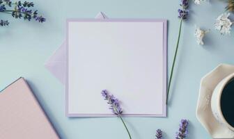 White blank card in a purple frame on a pastel periwinkle table, with a sprig of lavender and a small notebook photo