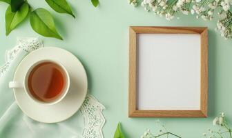 White blank card in a wooden frame on a pastel green table photo