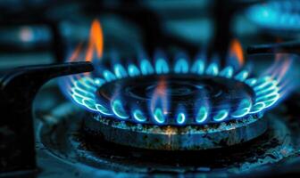 Macro photograph of a gas stove burner with a controlled blue flame photo