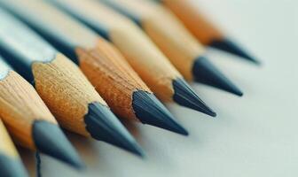 A close-up of graphite pencils neatly arranged on a pristine white drafting table photo