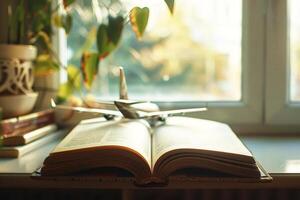 Immigration education program concept. International students and visa. Travel and learning and research the world. Opened book with airplane as a bookmark in front of window. photo