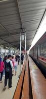 View of the Pasar Senen train station area. Local train and passengers activity. Jakarta, Indonesia - June 8, 2024 photo