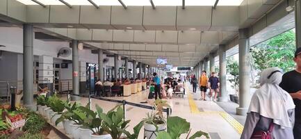 View of the Pasar Senen train station area. Local train and passengers activity. Jakarta, Indonesia - June 8, 2024 photo