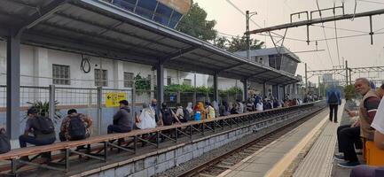 Atmosphere at railway train station. Local train activity in Indonesia. Railway road. Jakarta, Indonesia - Mei 28 2024 photo
