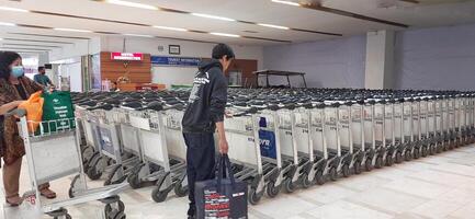 View of passengers activity and interior at Sultan Hasanuddin International Airport. Makassar, South Sulawesi Indonesia - June 11 2024 photo