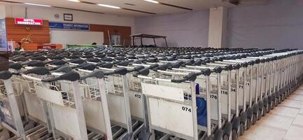 View of passengers activity and interior at Sultan Hasanuddin International Airport. Makassar, South Sulawesi Indonesia - June 11 2024 photo