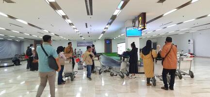 View of passengers activity and interior at Sultan Hasanuddin International Airport. Makassar, South Sulawesi Indonesia - June 11 2024 photo
