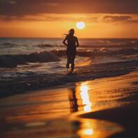 a woman running on the beach at sunset photo