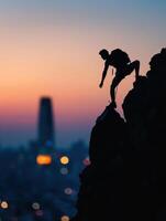 silhouette of a man climbing on a mountain at sunset photo