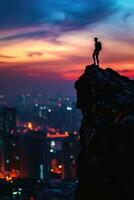 man standing on top of a mountain at sunset photo