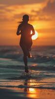 a woman running on the beach at sunset photo