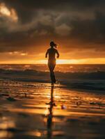 a woman running on the beach at sunset photo