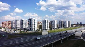 Landscape on the city.Stock footage.A bright city from a drone with new buildings, roads with transport, factories and blue sky overhead are visible. video