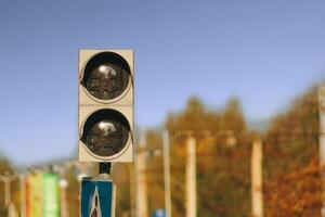 Not working traffic light with a pedestrian crossing against the sky photo