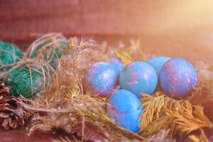 space galactic Easter eggs in nest next to cone and green filler photo