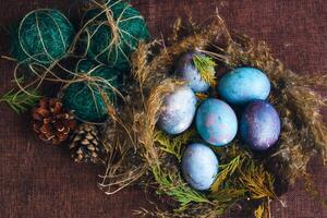 space galactic Easter eggs in nest next to cone and green filler photo
