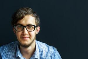 Man in glasses. Confident boy in eyeglasses looking at camera and smiling. photo