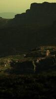 A view of a rocky mountain with a green sky in the background video