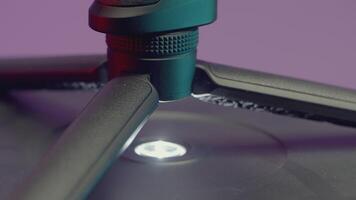 part of the stabilizer. ACTION. The stabilizer is shown rotating along the axis. On a purple background, they remove the stabilizer for shooting video