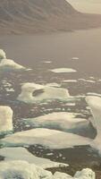 A serene scene of floating icebergs in a vast body of water video