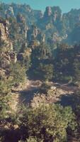 A view of a mountain range with trees and rocks video