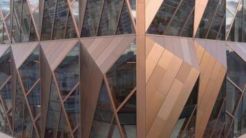 Russia, Yekaterinburg - May 13, 2022. Top view of modern architecture of office building. Stock footage. Glass windows with stylish design of architecture of modern building. Headquarters of Russian video