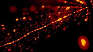 Abstract rays of shining particles on a black background. Motion. Red and yellow lights in flight. video