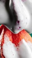 Colorful cookies in liquid cream. Stock clip. White cream flows down colorful cookies. Creative with sweets and chromakey video