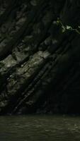 A large cave. Creative.A huge rock from which cold drops drip into the pond from below. video