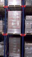 Lots of storage shelves with boxes. Creative. Storage room with lot of sealed goods on shelves. Boxes in large warehouse with row numbers video