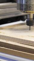 Close-up of carpenter's machine cutting wooden boards. Media. Beautiful patterns on wood with automated machine. Wood carving by automated machine video