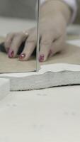 Garment fabric cutting is done in a workshop using hands and tools with precision and craftsmanship video