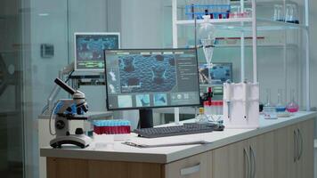 Empty laboratory space with biochemistry equipment used for research industry. Scientific room with nobody at chemistry workplace desk. Microscope, pipette and test tubes on table video
