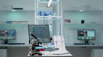 Nobody in scientific laboratory with research instruments for healthcare treatment innovation. Empty room of biochemistry labware with computer, test tube, microscope used in development video