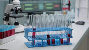 Close up of glassware for fluid solution or dna in laboratory on desk. Chemistry tray with sample test tubes for scientific experiment. Blood and liquid flasks prepared for analysis video