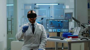 Professional scientist using medical inovation in lab wearing virtual reality glasses, gesticulating. Team of researchers working with equipment device, future, medicine, healthcare, vision, simulator video